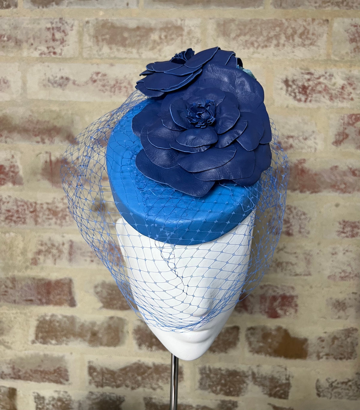 Millinery | Blue leather button
