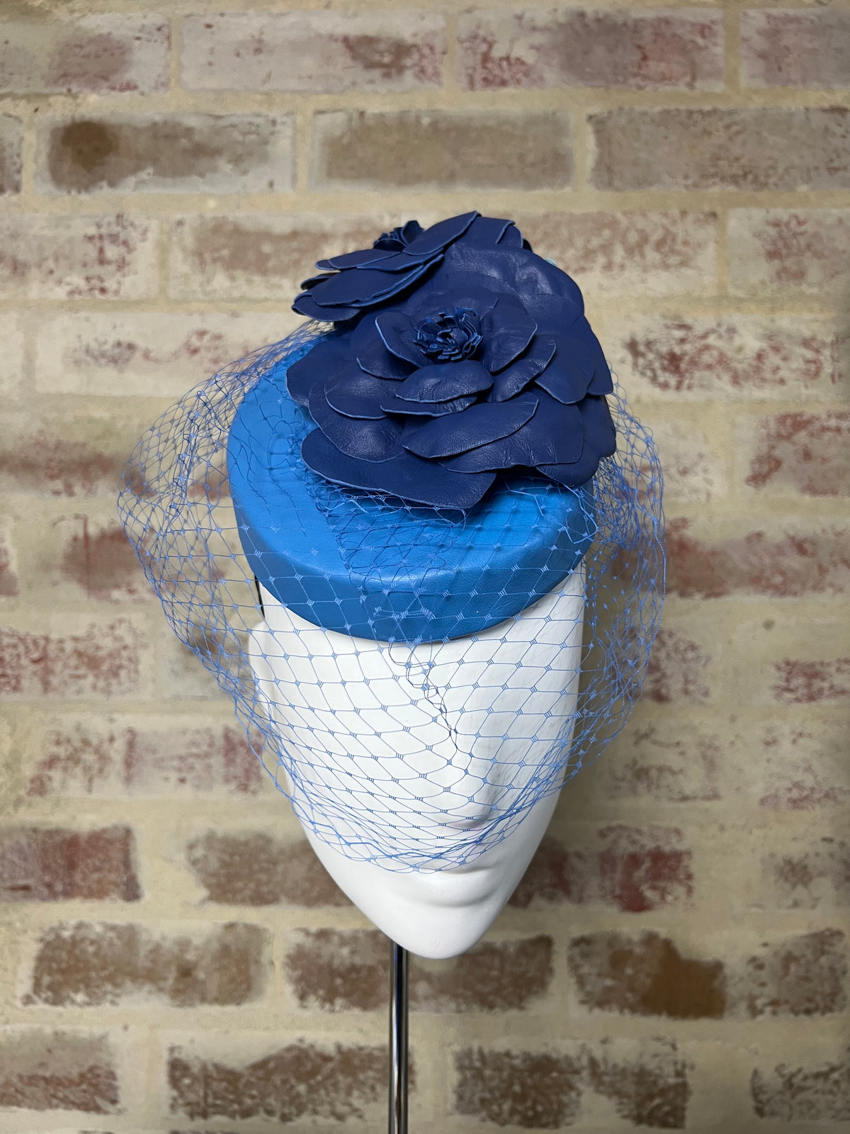 Millinery | Blue leather button